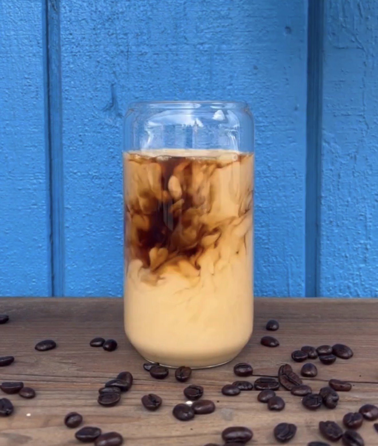 Iced coffee being poured over cream